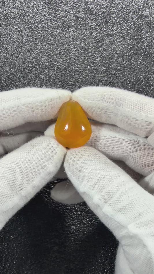 Close-up video of a one-of-a-kind Juniper Ridge Fire Opal cabochon from Oregon showing its polished surface, edges, and natural coloratio