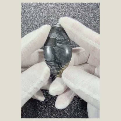 Natural Picasso Jasper cabochon displayed beside a ruler to show its actual dimensions and polished shape.