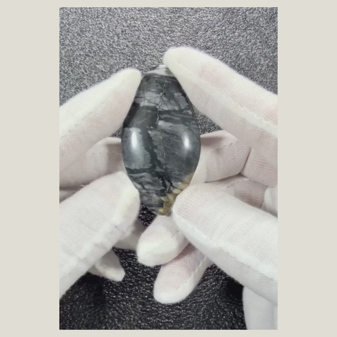 Natural Picasso Jasper cabochon displayed beside a ruler to show its actual dimensions and polished shape.