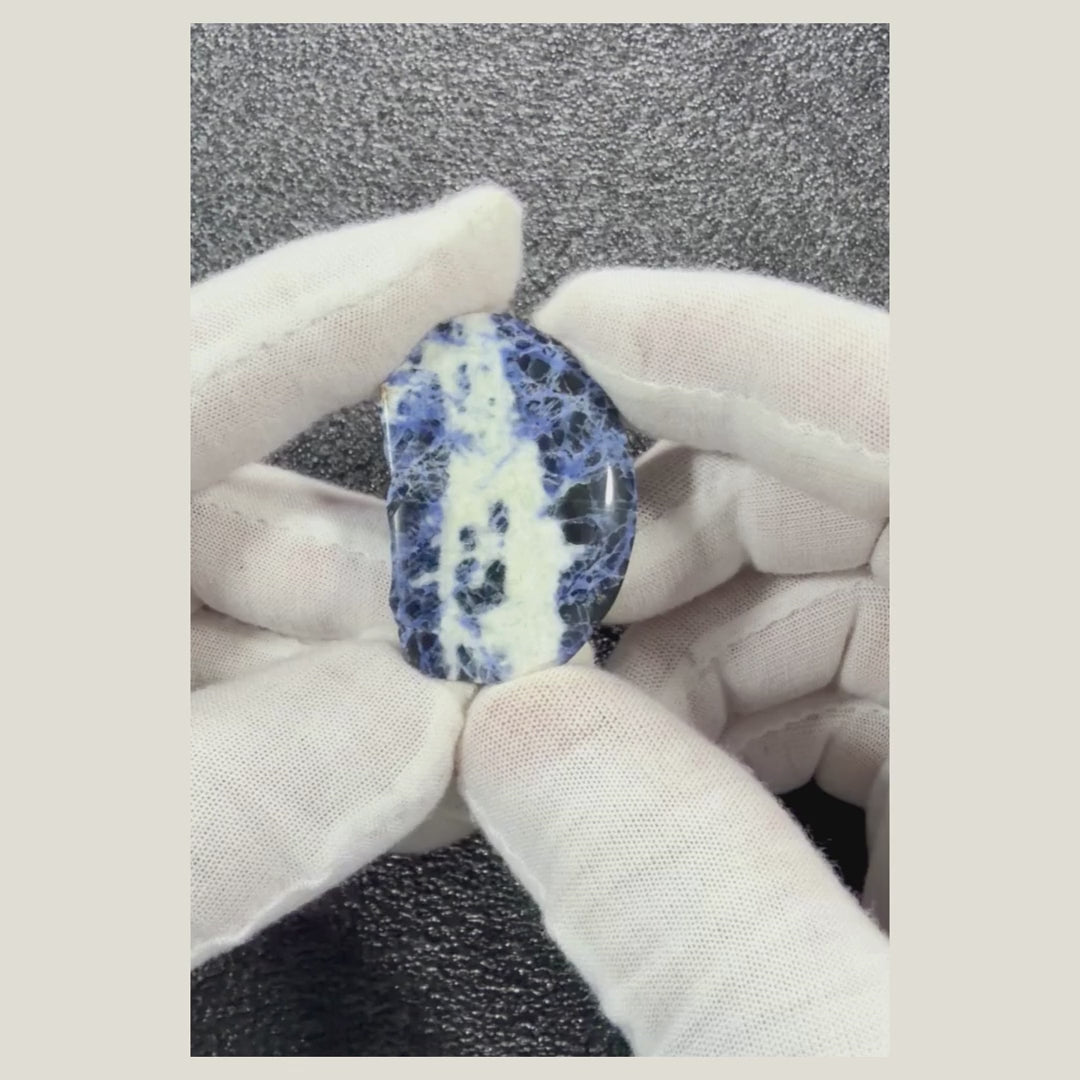 Video displaying a polished Sodalite cabochon from multiple angles to reveal its natural blue coloring.