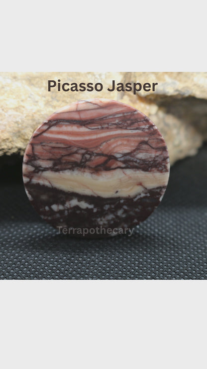 Video showing a hand-cut round Picasso Jasper cabochon with flowing layers of peach, rust, cream and dark brown, polished by Jody at Terrapothecary.