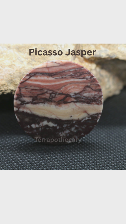 Video showing a hand-cut round Picasso Jasper cabochon with flowing layers of peach, rust, cream and dark brown, polished by Jody at Terrapothecary.
