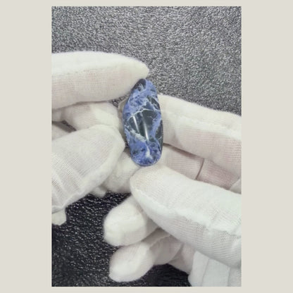 Rotating view of a one-of-a-kind Sodalite cabochon showing its natural patterns and polished surface.