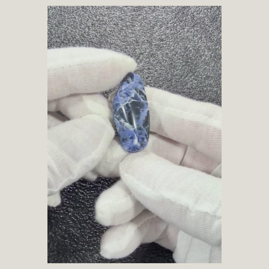 Rotating view of a one-of-a-kind Sodalite cabochon showing its natural patterns and polished surface.