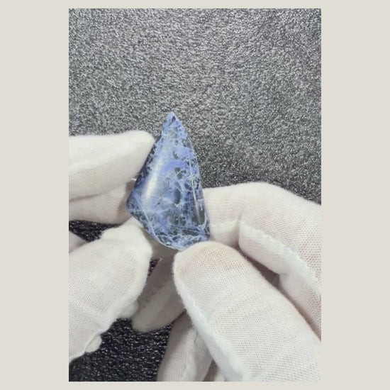 Video displaying a polished Sodalite cabochon from multiple angles to reveal its natural blue coloring.