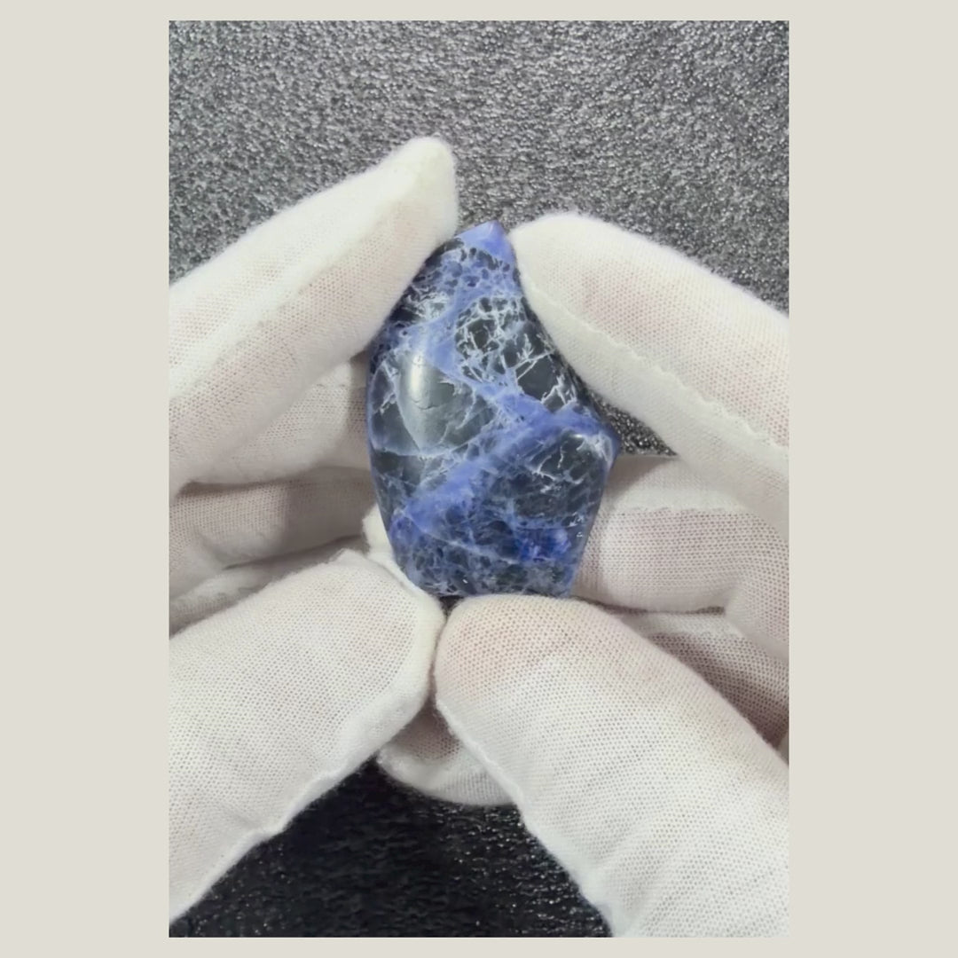 Rotating video showcasing the unique patterns and polished surface of a genuine Sodalite cabochon.