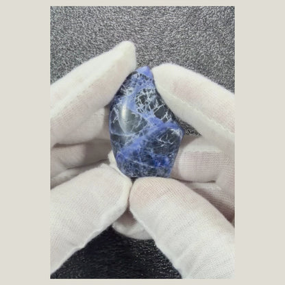 Rotating video showcasing the unique patterns and polished surface of a genuine Sodalite cabochon.