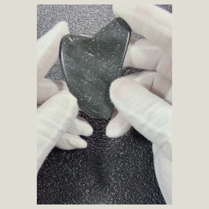 Rotating video of a polished Black Obsidian massage heart highlighting its glossy black finish and heart shape.
