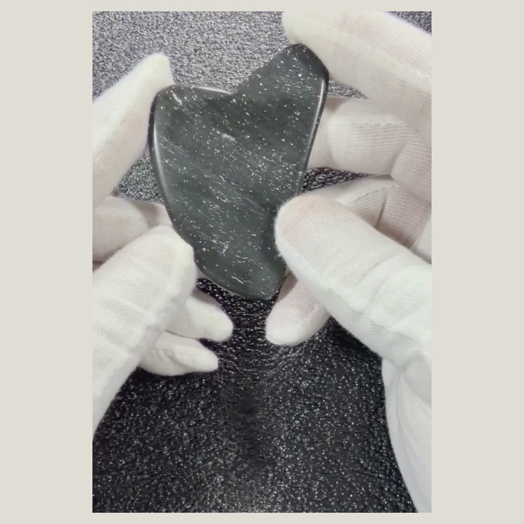 Rotating video of a polished Black Obsidian massage heart highlighting its glossy black finish and heart shape.