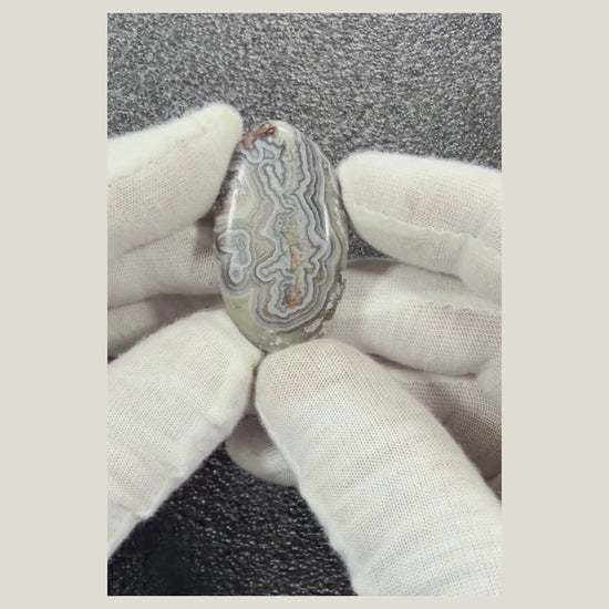 Product video featuring a polished Crazy Lace Agate cabochon with distinctive natural patterns, smooth finish, and beautiful earthy tones
