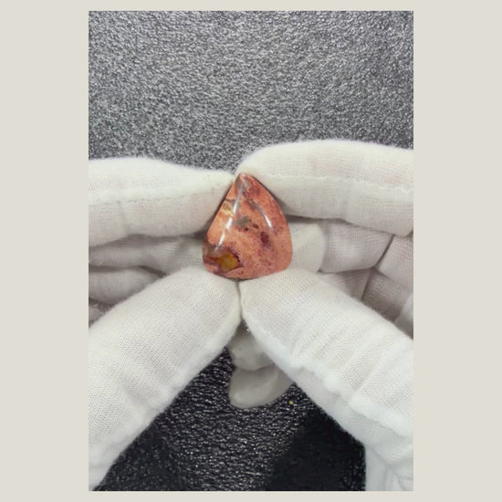 Rotating product video of a genuine Brecciated Jasper cabochon displaying its polished finish and beautiful natural stone characteristics.
