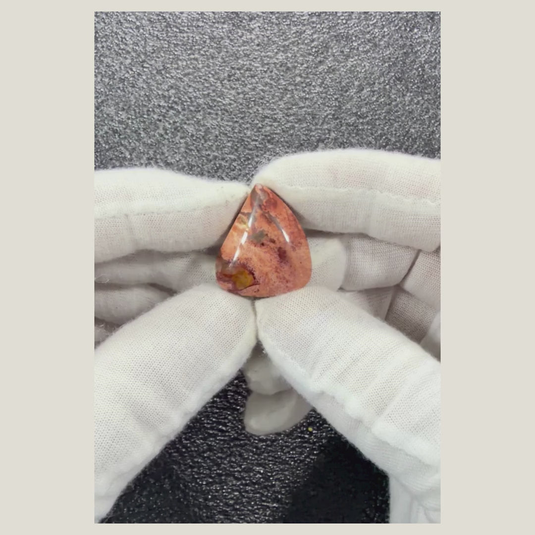 Rotating product video of a genuine Brecciated Jasper cabochon displaying its polished finish and beautiful natural stone characteristics.