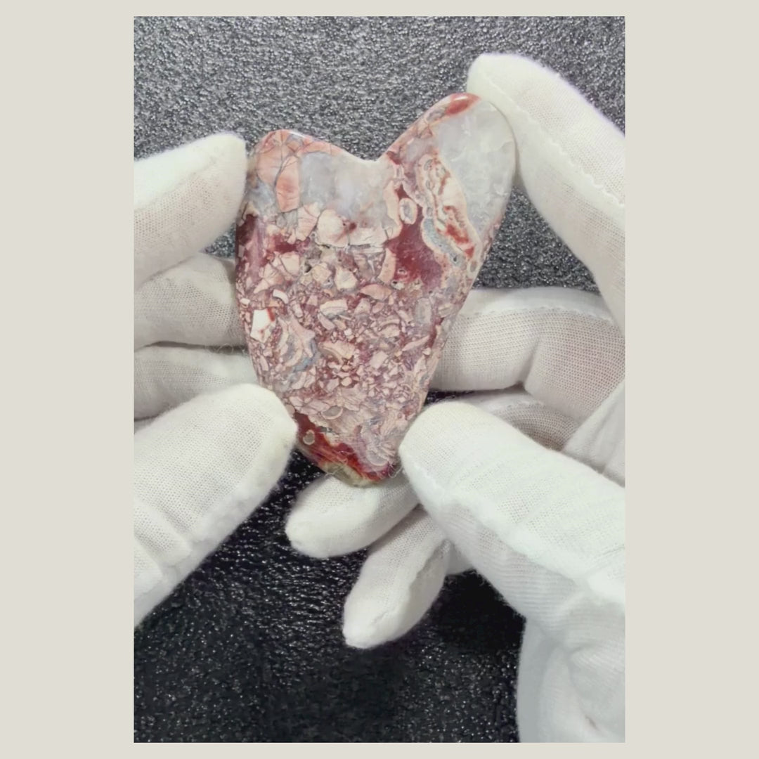 Rotating video of a genuine Brecciated Jasper massage heart highlighting its polished finish and unique natural patterns.