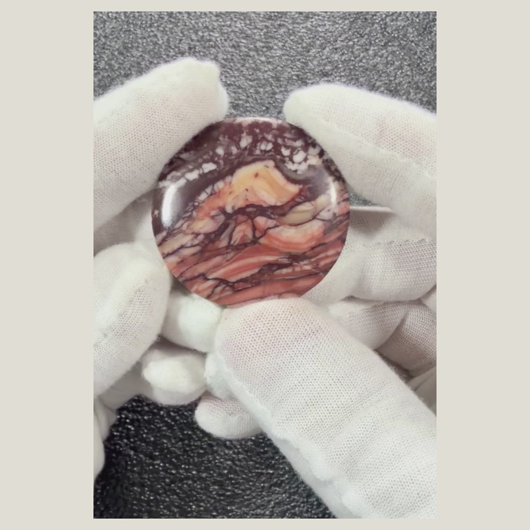 360-degree video of a natural Picasso Jasper cabochon highlighting its unique black and gray line patterns and polished finish.