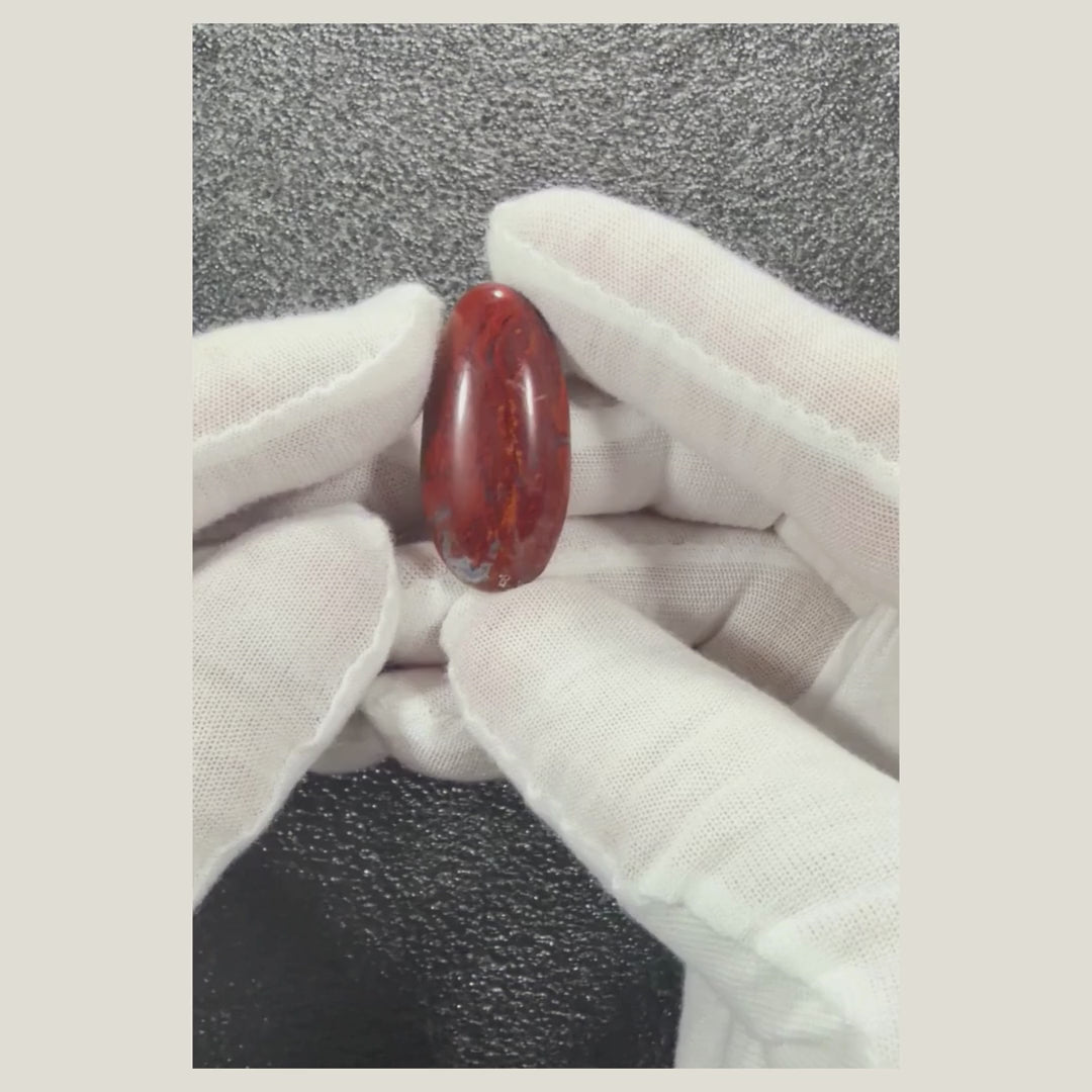 Close-up rotating video of a natural Brecciated Jasper cabochon featuring polished surfaces and one-of-a-kind earthy coloration.