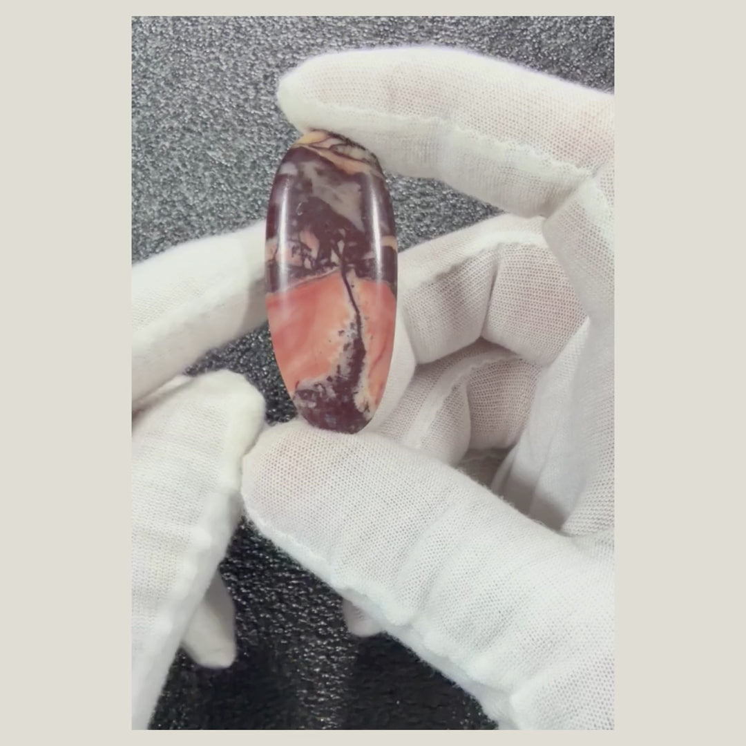 Rotating video showcasing a genuine Picasso Jasper cabochon with distinctive artistic veining and natural earth-tone colors.