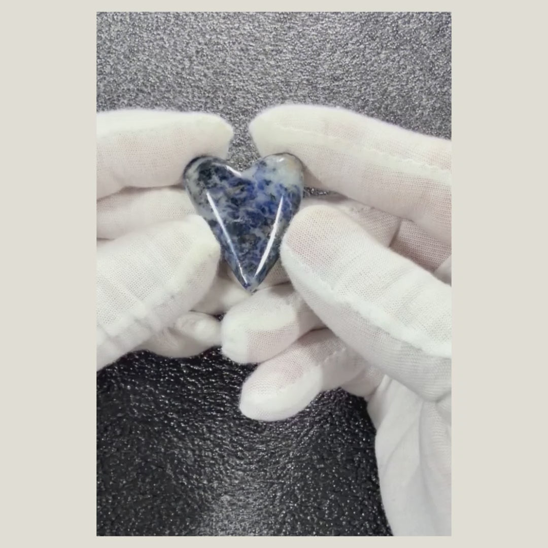 360-degree video of a natural Sodalite cabochon highlighting its polished finish, blue color, and white veining.