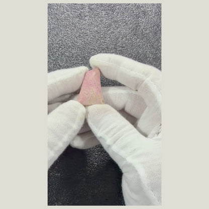 Close-up video of a Natural Rhodonite Cabochon highlighting natural color, pattern, and craftsmanship