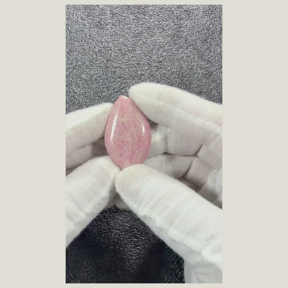360-degree video of a Natural Rhodonite Cabochon displaying front, back, and polished edges