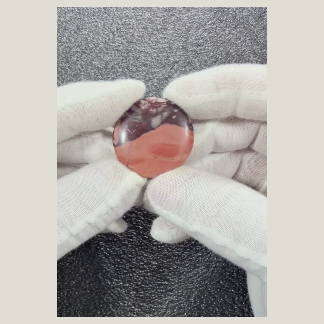 Rotating video showcasing a genuine Picasso Jasper cabochon with distinctive artistic veining and natural earth-tone colors.